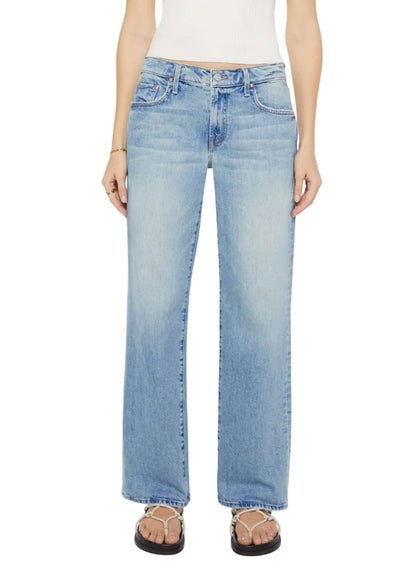 A person wearing Mother’s Mid Rise Zip Rambler Skimp jeans in light blue denim, a white ribbed sleeveless top, and black sandals.