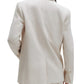 A person is shown from the back wearing a light-colored TWP Tabitha Blazer, with focus on the cotton linen fabric, seam detail, and buttoned sleeves.