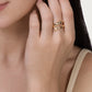An 18K gold plated Milos Fish Ring shaped like a stylized fish wrapped around a finger.