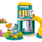 The LEGO® Playground Fun with Bluey and Chloe by Legos - Toyhouse features a two-story building with a yellow slide, ladder, tic-tac-toe board, animal figures, cupcakes, teapot, and campfire—ideal for preschool playground adventures!.