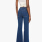 A person stands with their back to the camera, wearing Mother’s The Patch Pocket Doozy high-rise flare jeans in dark blue denim and a white sleeveless top, set against a plain white background.
