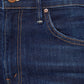 Close-up of the front pocket and waistband on Mother’s The Insider Crop Step Fray high-waisted bootcut jeans in blue denim, featuring visible stitching and a metal button.