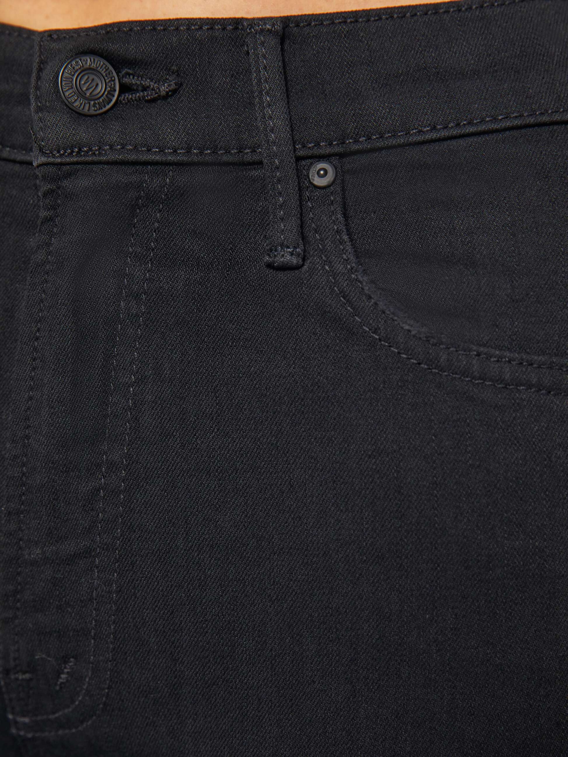 Close-up of the upper section of The Insider Crop Step Fray high-waisted bootcut black jeans by Mother, highlighting the waistband, button, front pocket, and belt loop.