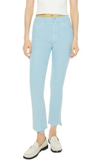 A person is sporting the Mother Denim The Insider Crop Step Fray jeans, which are light blue and made of stretch denim, paired with a white top and matching white loafers.