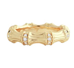The Bamboo Single Ring by Anabel Aram is crafted in 18k gold with clusters of small round diamonds set between textured bamboo-inspired segments for a distinctive design.