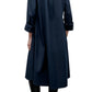 Person shown from the back wearing TWP's Hankerchief Midi Jenny's Gown—a long-sleeve, dark blue cotton shirt dress with rolled cuffs—paired with black knee-high boots.