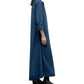 A person in profile models the Jenny's Cotton Gown by TWP, an oversized maxi shirt dress made from Italian cotton shirting with rolled sleeves, styled with black boots against a white background.
