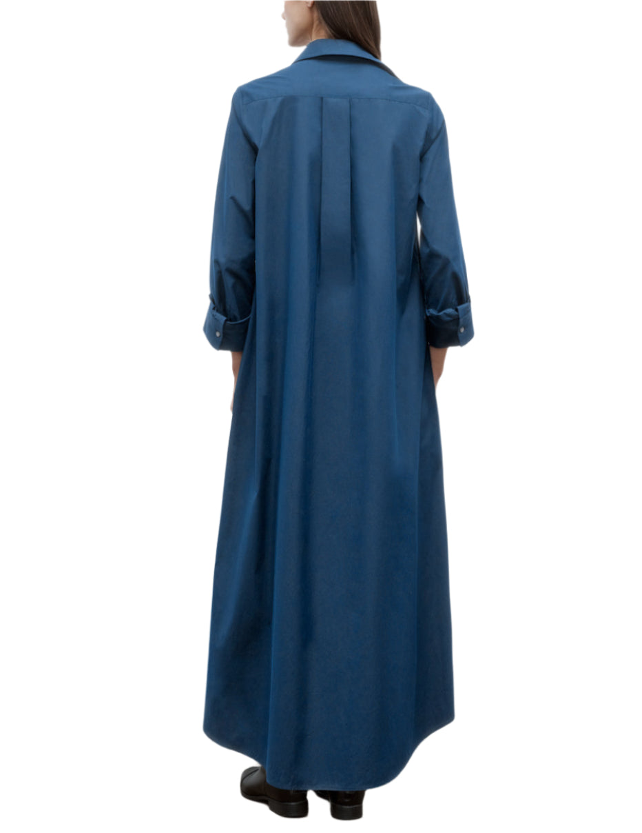 A person is shown from the back wearing TWP's Jenny's Cotton Gown, an oversized A-line maxi shirt dress in blue Italian cotton shirting, styled with black shoes against a plain white background.