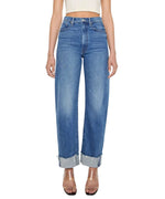 Wearing Mother’s Half Pipe Flood Cuff Fray high-waisted, wide leg jeans crafted from SUPERIOR denim with large cuffs and pairing them with a white crop top, the look is finished with clear heeled sandals.