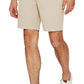 Man wearing slim fit AG Jeans Wanderer Short beige shorts and white sneakers.