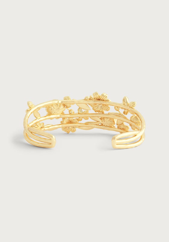 The Anabel Aram Wildflowers Bangle is an 18k gold open cuff bracelet featuring an intricate floral and leaf design, adding elegance to any look.