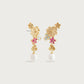 The Wildflowers Pearl Drop Earrings by Anabel Aram feature gold floral designs with pink, blue, and white accents and a dangling white pearl. These 18k gold-dipped earrings are a stunning piece of handcrafted jewelry.