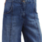 Close-up of the Dancing In The Dark Jeans by TWP featuring a relaxed fit, ultra-wide legs, front pockets, and a button closure in blue denim.