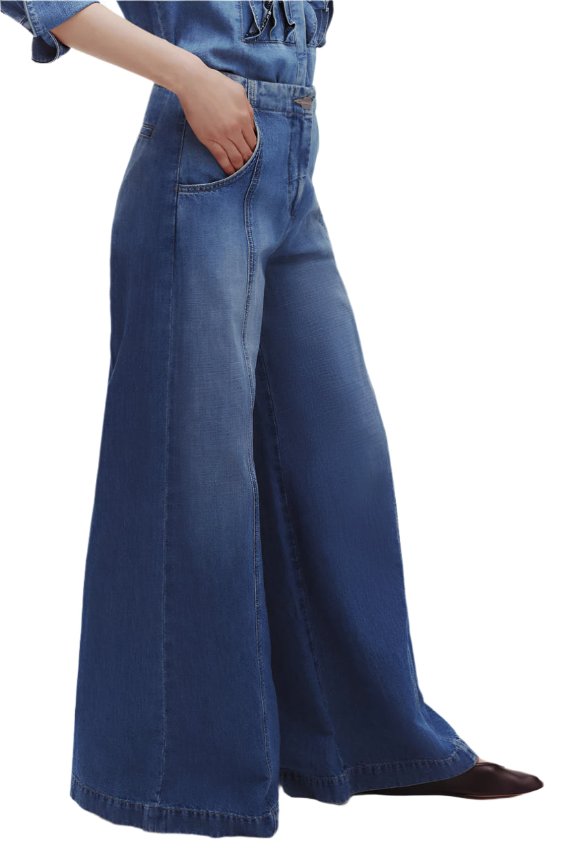 Wearing TWP's Dancing In The Dark Jeans, someone effortlessly styles the ultra wide leg lightweight denim with a hand in the pocket and pairs them perfectly with pointed-toe shoes.