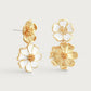 The Anabel Aram Wildflowers Mixed Drop Earrings feature three gold and white enamel flower shapes with detailed petals and textured centers, bringing a touch of nature-inspired elegance to your look.