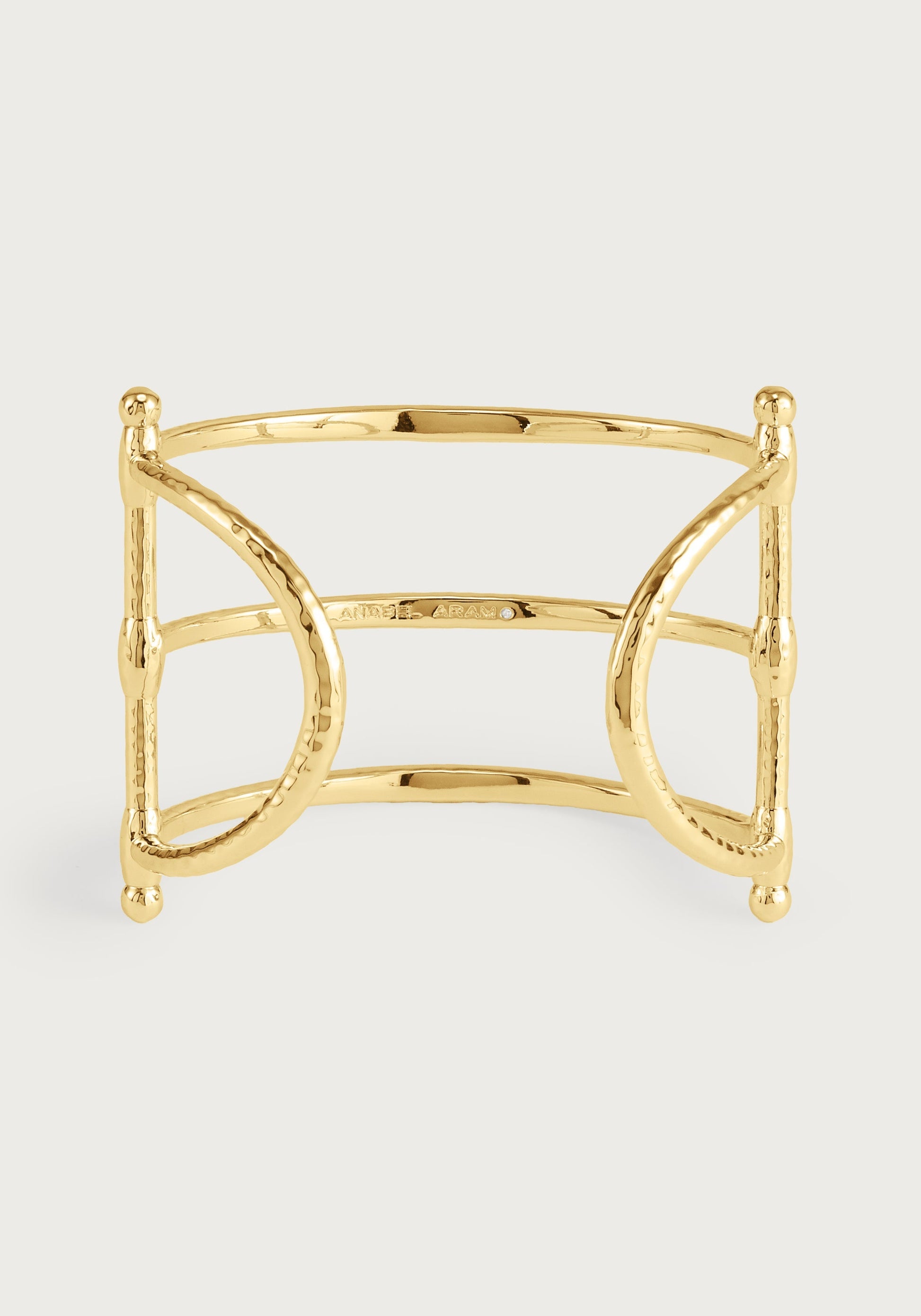 The Cheval Bit Cuff by Anabel Aram is a polished gold, open cuff bracelet with a geometric, horse bit-inspired design and rounded ends, offering sculptural elegance in equestrian style.