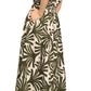 Woman wearing the Cara Cara Asbury Midi Dress in a green and white leaf pattern with short sleeves and self-tie waist, paired with tan sandals, standing in profile against a white background.