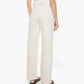 A person stands facing away wearing the Dodger Skimp high-waisted, loose straight leg pants in SUPERIOR cotton by Mother and a sleeveless top.
