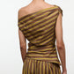 A person is photographed from the back against a plain white background, wearing the Staud Phare Top—a brown and yellow striped, off-the-shoulder top—paired with matching striped pants.