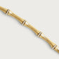 A modern heirloom, the Bamboo Necklace by Anabel Aram features 18k gold dipped brass in a bamboo design with crystal-studded accents at each joint, shown on a plain white background.
