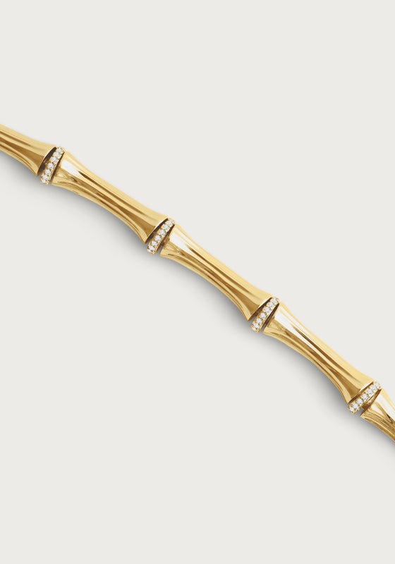 A modern heirloom, the Bamboo Necklace by Anabel Aram features 18k gold dipped brass in a bamboo design with crystal-studded accents at each joint, shown on a plain white background.