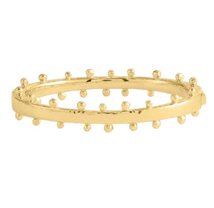 The Milos Gold Hinged Bangle by Anabel Aram features a smooth band accented with evenly spaced small round studs, inspired by refined style.