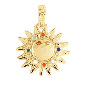 The Milos Soleil Charm by Anabel Aram is a gold sunburst necklace with a round center and small multicolored stones, inspired by a Mediterranean sun.