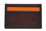 The Magnanni Card Holder, a textured dark brown wallet with card slots, is displayed against a white background with an orange card partially visible in the top slot.