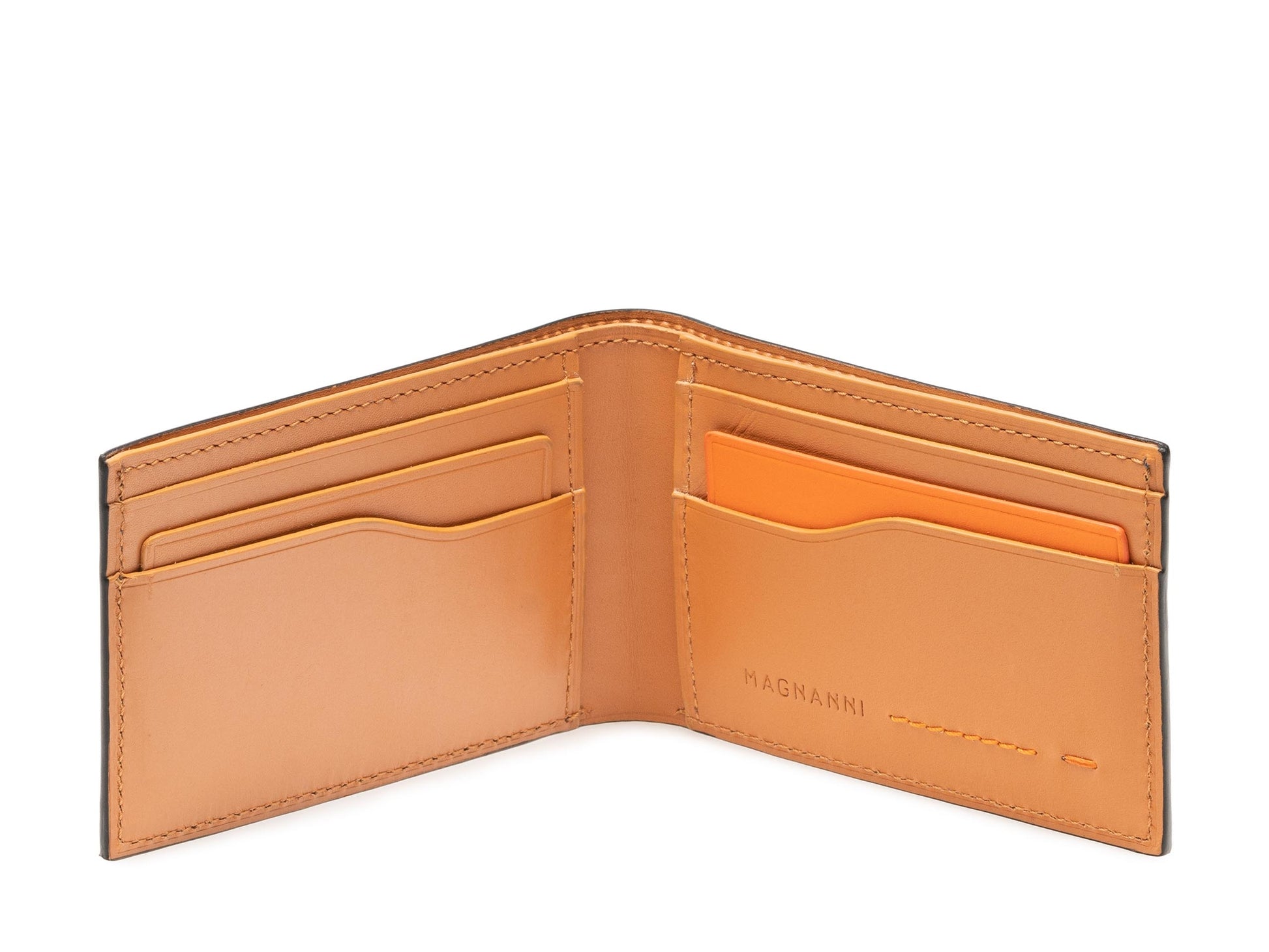 The Slim Fold Wallet by Magnanni features tan calfskin leather, multiple card slots, an interior orange accent, and the brand’s name inside—a refined choice for everyday use.