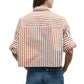 Model wears the TWP Next Ex Stripe Shirt, a brown and white vertically striped, cropped button-down with rolled sleeves and a boxy silhouette, paired with blue jeans and shown from the back.