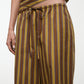 A person lifts the top of their brown and blue striped outfit to reveal the drawstring waist and waistband of Staud’s Mateo Cotton Poplin Pant.