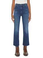 A pair of Mother Denim The Hustler Ankle high-rise skinny-flare jeans paired with brown boots against a white background.