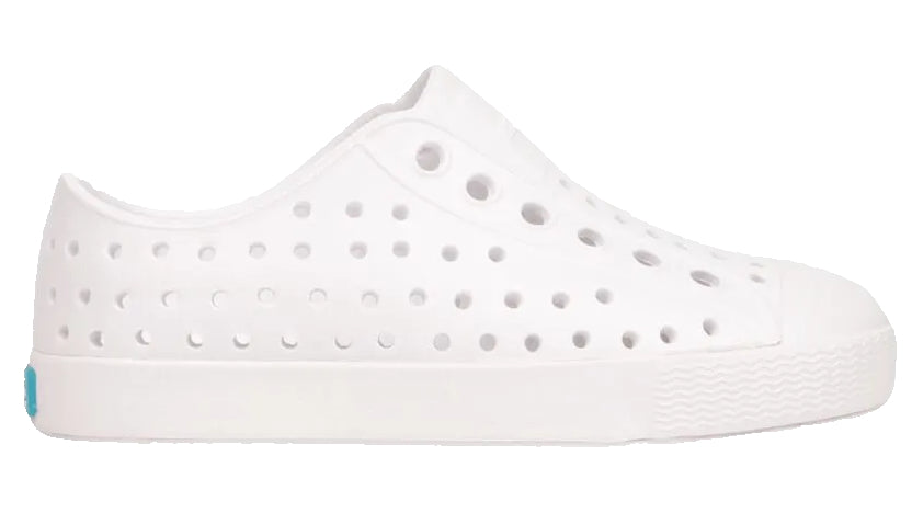 The Kids’ Jefferson Shoes by Native Shoes are lightweight, water-friendly slip-ons featuring multiple ventilation holes and a textured toe and sole, shown here on a plain white background.