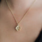 The Anabel Aram Wildflowers Pendant Necklace, dipped in 18k gold, showcases a textured wildflower pendant that adds an elegant touch against bare skin or dark clothing.