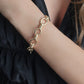 Gold-tone Anabel Aram Neptune Chain Bracelet featuring alternating smooth and textured circular links on a person’s wrist.