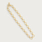 The Anabel Aram Neptune Chain Necklace features circular links with textured detailing, dipped in 18k gold for a radiant finish—an elegant piece shown on a plain white background.