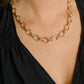 Gold-tone Neptune Chain Necklace featuring interlocking circular links with textured bands and a lobster clasp.