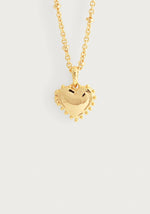 The Anabel Aram Heart Locket Necklace features a puffy, gold-dipped brass heart pendant with small round accents, creating a charming keepsake locket displayed on a plain white background.