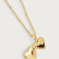 The Anabel Aram Heart Locket Necklace features gold dipped brass and a beaded chain, opening to reveal two hollow heart halves—a timeless keepsake for your cherished memories.