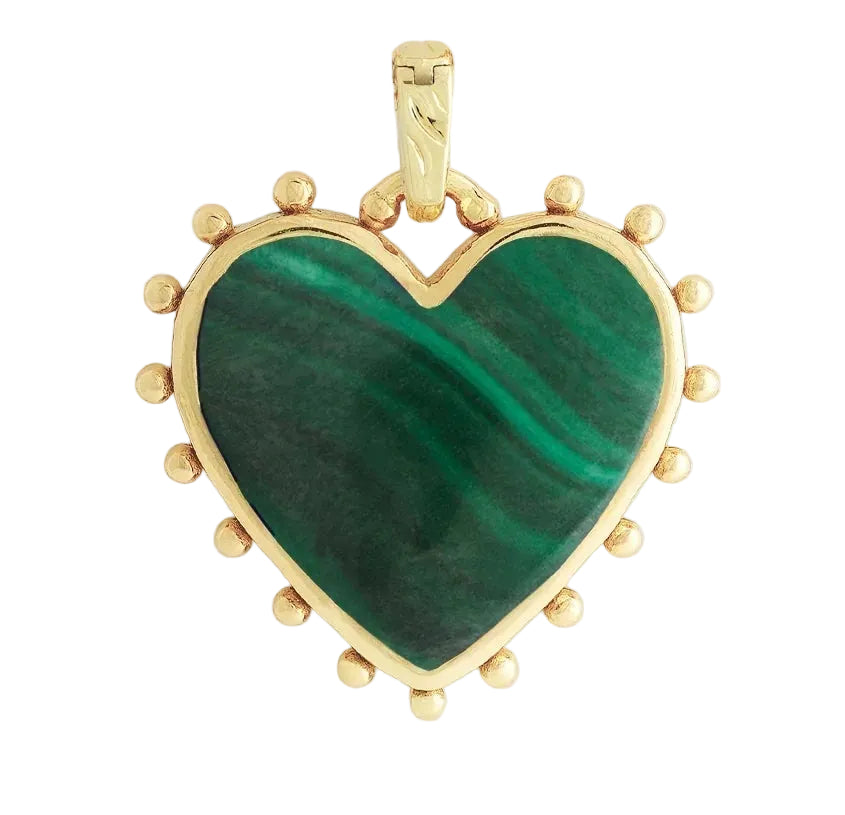 The Heart with Stone Charm by Anabel Aram features a green heart-shaped gemstone with gold accents and charming dot details around the edge.