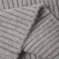 Close-up of a folded gray knitted fabric with a ribbed texture, reminiscent of the cozy Girls’ Fuzzy Knit Lounge by Rylee & Cru, featuring soft, wide leg pants.