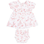 The Angel Dear Baby Girls’ Smocked Dress Set features a white dress with a pink toile pattern, short sleeves, and a charming Peter Pan collar, shown flat against a white background. This adorable set also includes matching bloomers for a timeless, classic look.