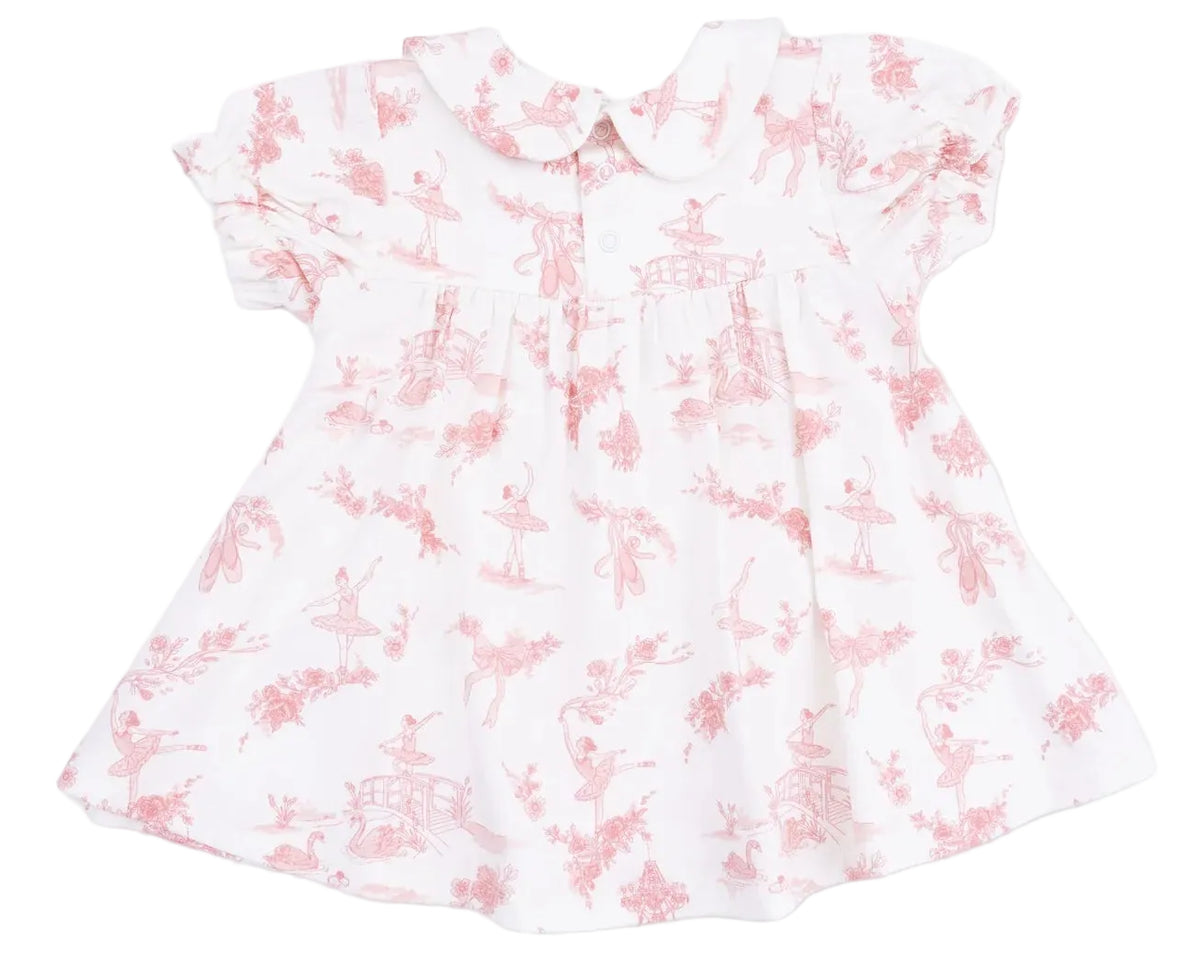 The Angel Dear Baby Girls’ Smocked Dress Set is a white dress with a pink toile print featuring ballerinas, flowers, and animals. This charming set includes classic details like a Peter Pan collar, short sleeves, and front pleats for timeless elegance.
