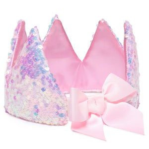 The Great Pretenders Ombre Sequins Crown is a pink satin crown decorated with ombre sequins and features a large pink bow on the front.