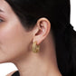 Small 18K gold plated Cheval Braided Hoop Earring worn in an earlobe.