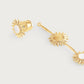 Anabel Aram Milos Soleil drop earrings in 18K gold plate featuring multiple sun-shaped charms with white circular inlays.