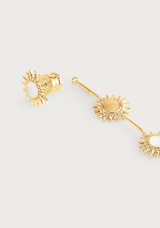 Anabel Aram Milos Soleil drop earrings in 18K gold plate featuring multiple sun-shaped charms with white circular inlays.