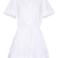 The Cara Cara Asbury Mini Dress is a white shirtdress with short sleeves, front buttons, a functional waist tie, and a flared mini-length skirt.