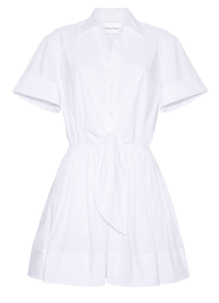 The Cara Cara Asbury Mini Dress is a white shirtdress with short sleeves, front buttons, a functional waist tie, and a flared mini-length skirt.