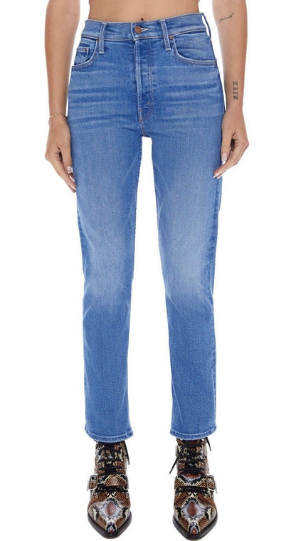 A woman wearing a pair of Mother Denim The Tomcat high-rise straight leg jeans with a cropped inseam and a crop top.